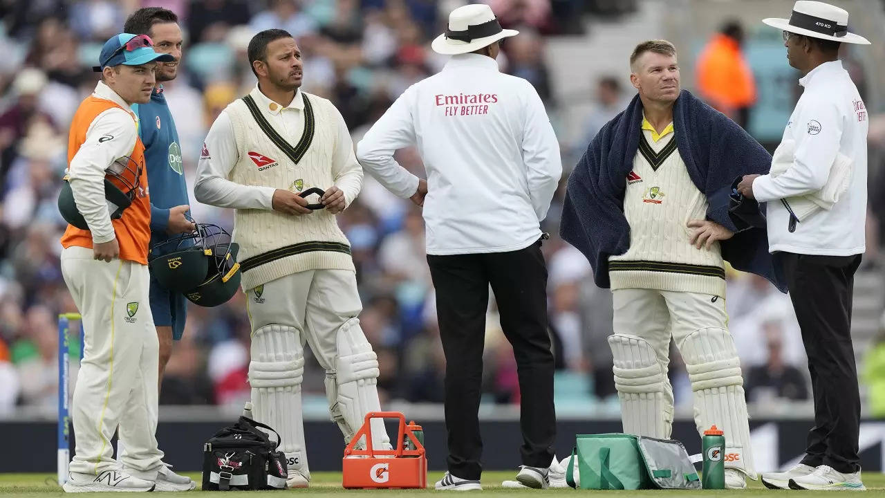 David Warnes and Usman Khawaja with Umpiers